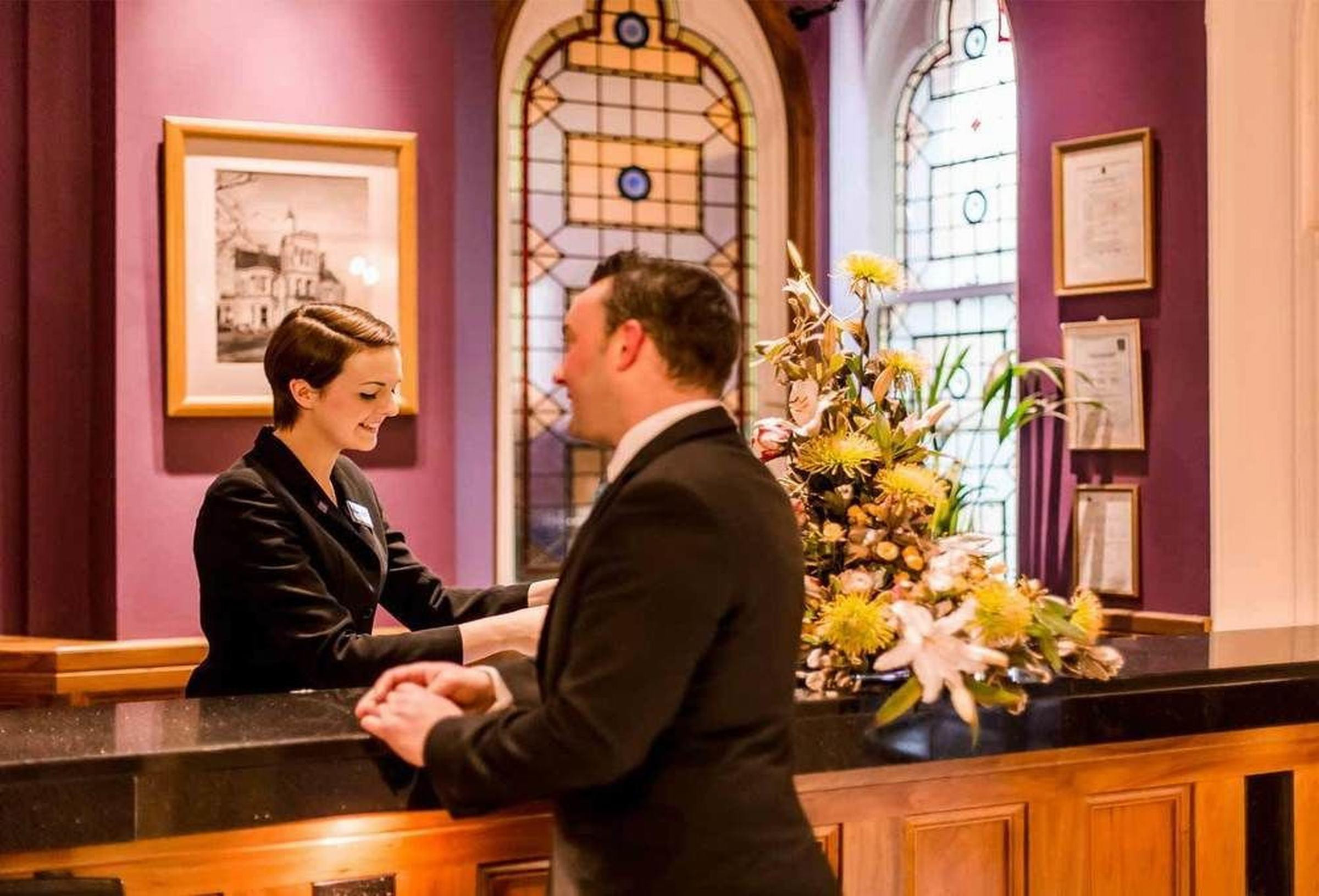 The Culloden Estate And Spa Холивуд Экстерьер фото A hotel receptionist at work