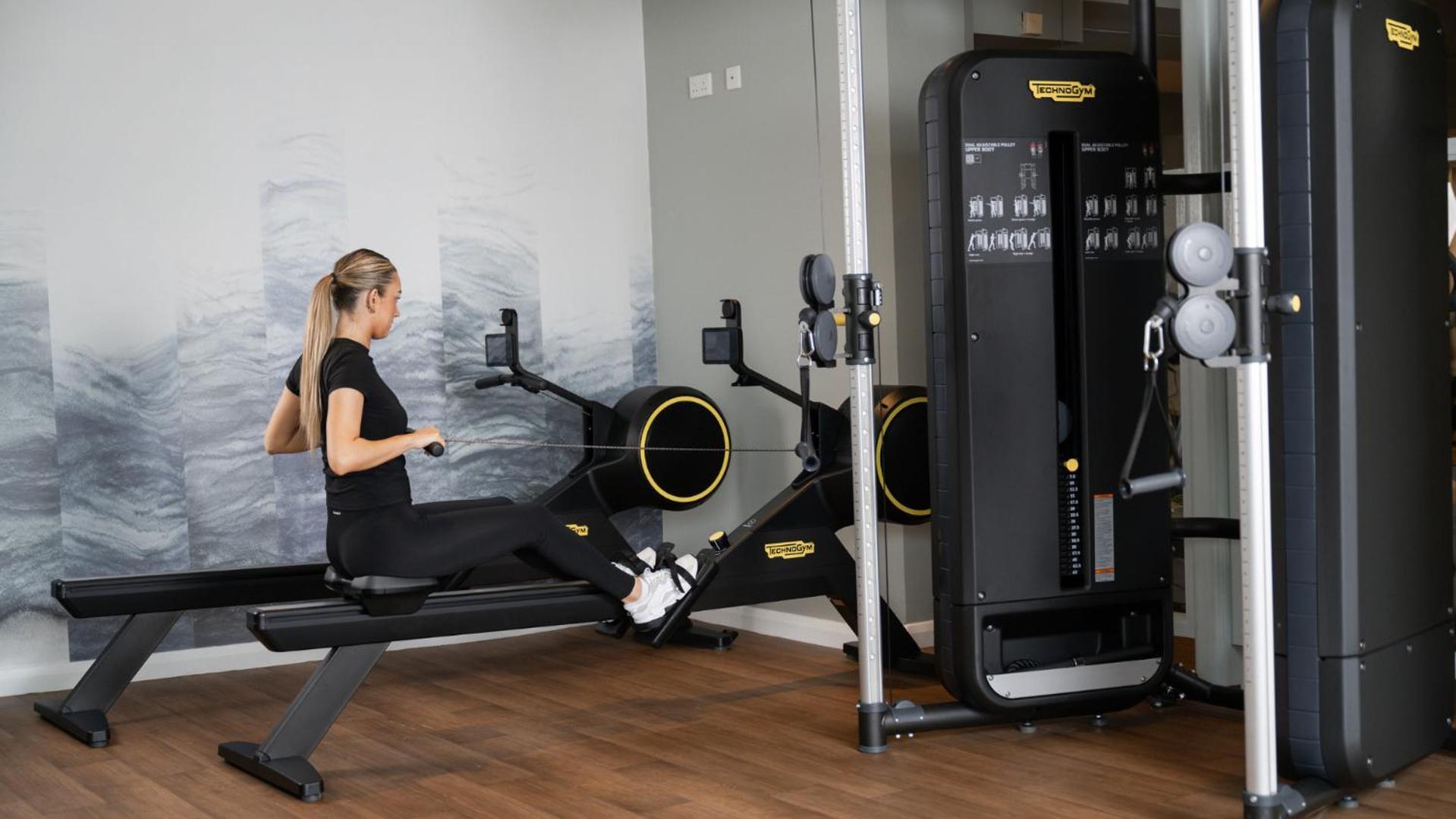 The Culloden Estate And Spa Холивуд Экстерьер фото A woman using a rowing machine
