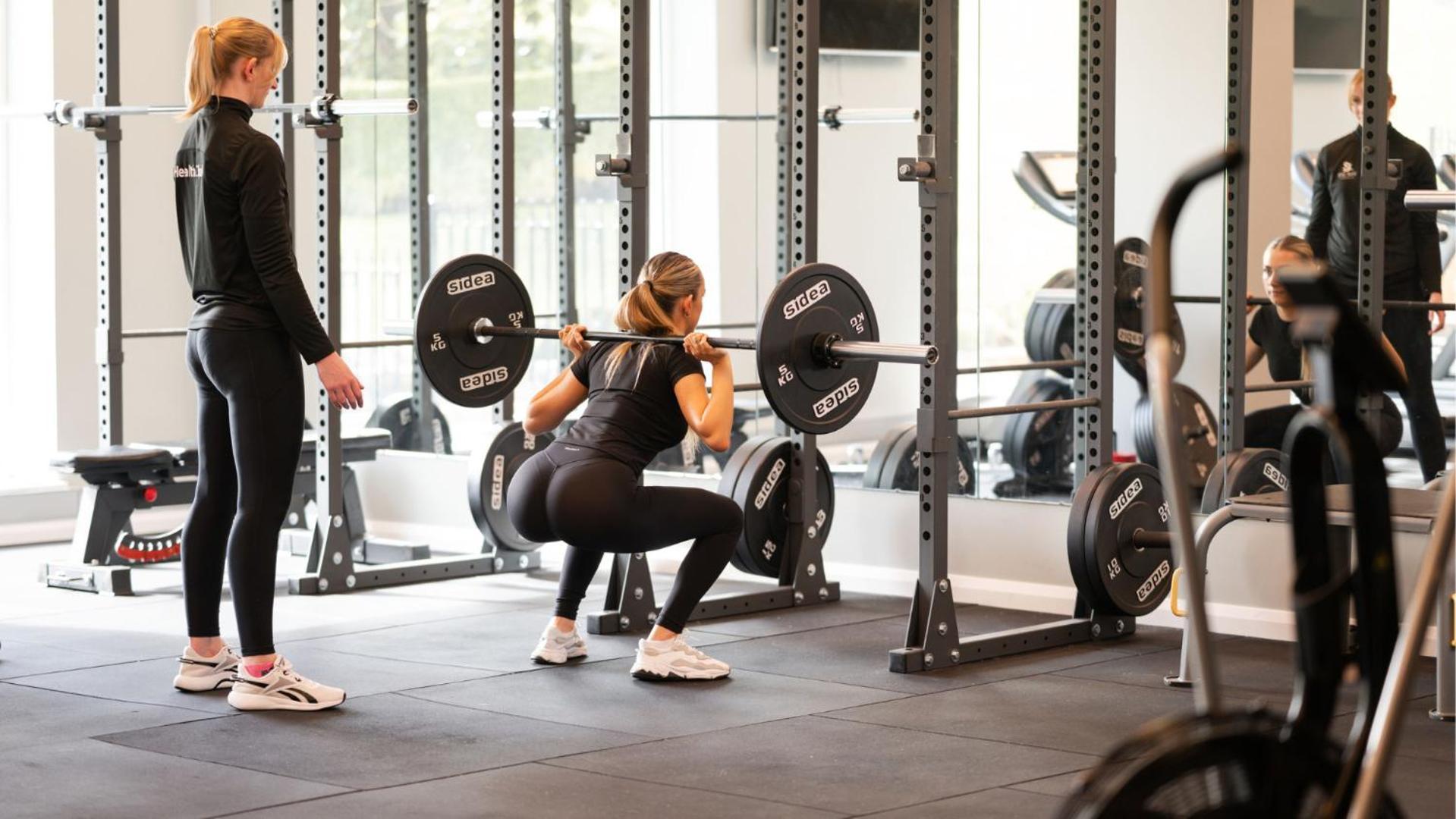 The Culloden Estate And Spa Холивуд Экстерьер фото A woman performing a back squat with a barbell